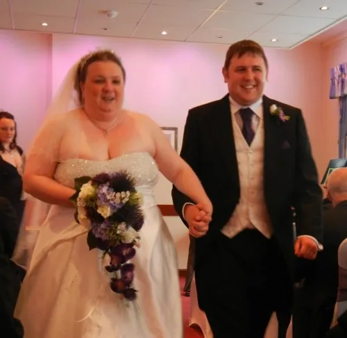 A photo of Christine and Neil leaving their wedding ceremony in 2013.