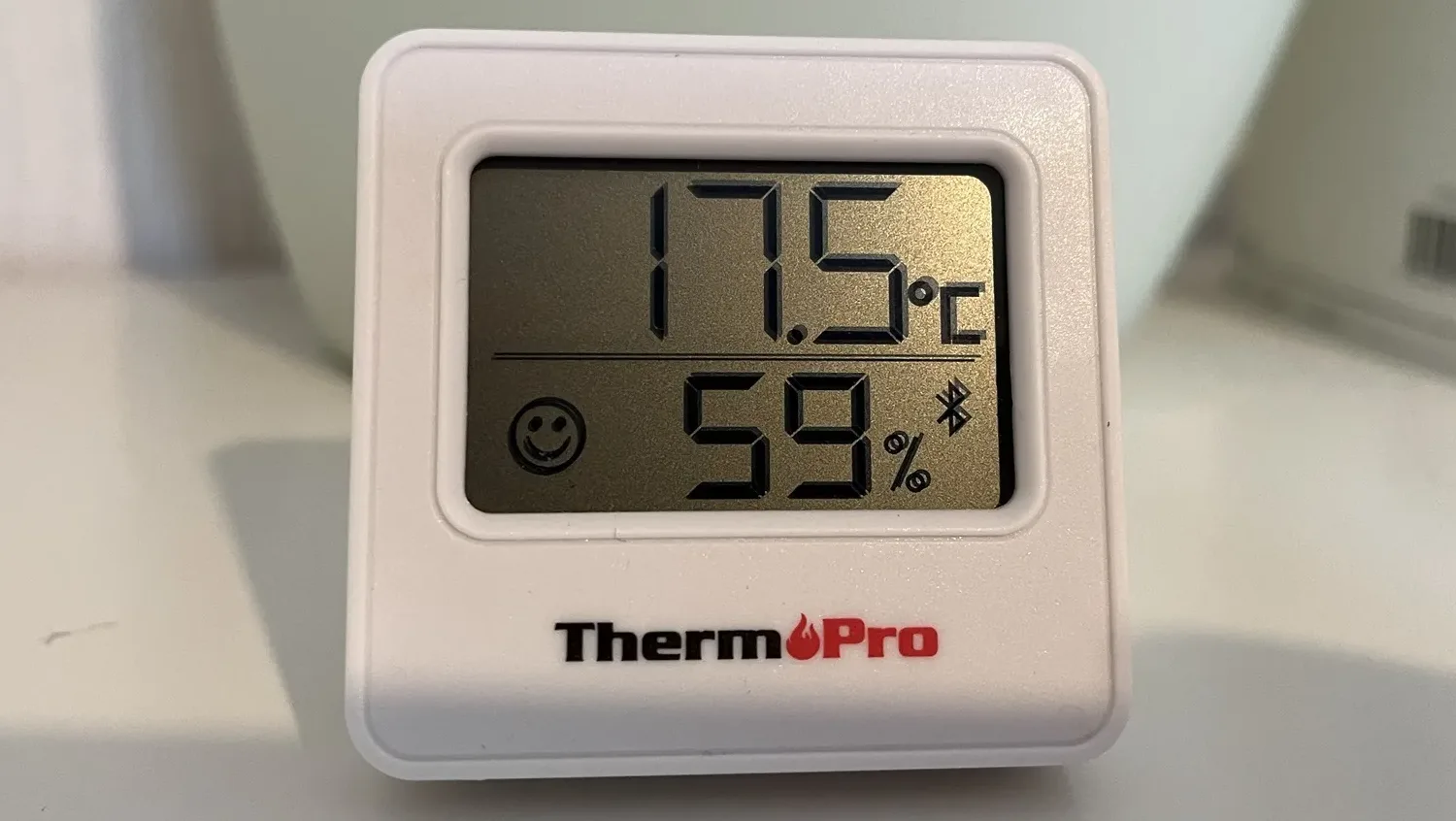 A photo of a ThermoPro TP357 thermometer showing the current temperature of 17.5℃ and humidity of 59% on a LCD display.