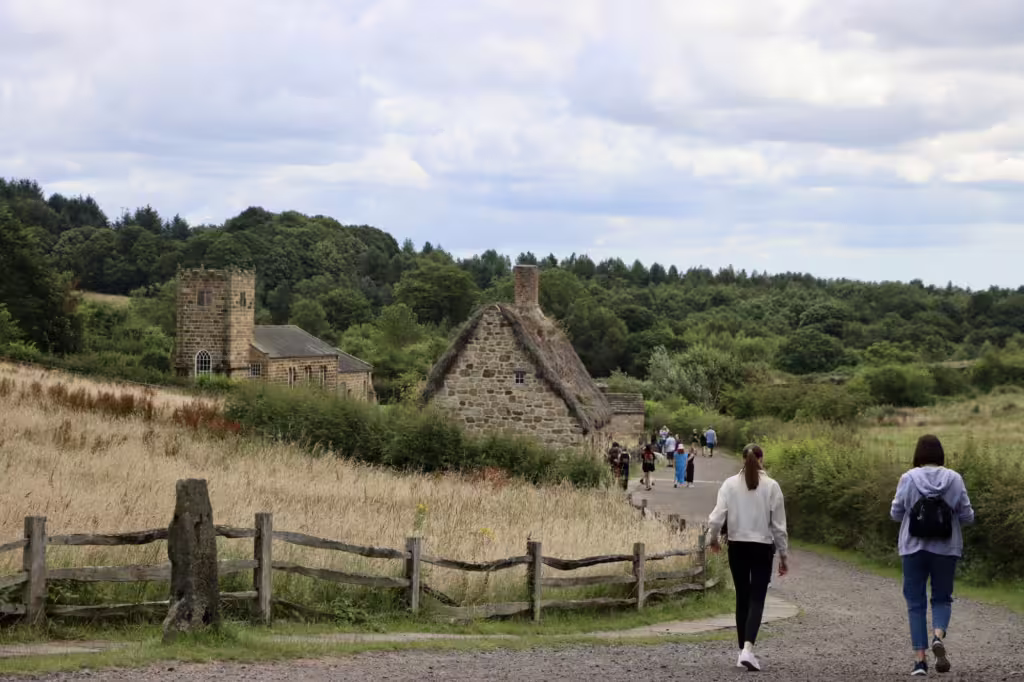 The 1820s landscape at Beamish. There is a thatched-roof cottage in the foreground