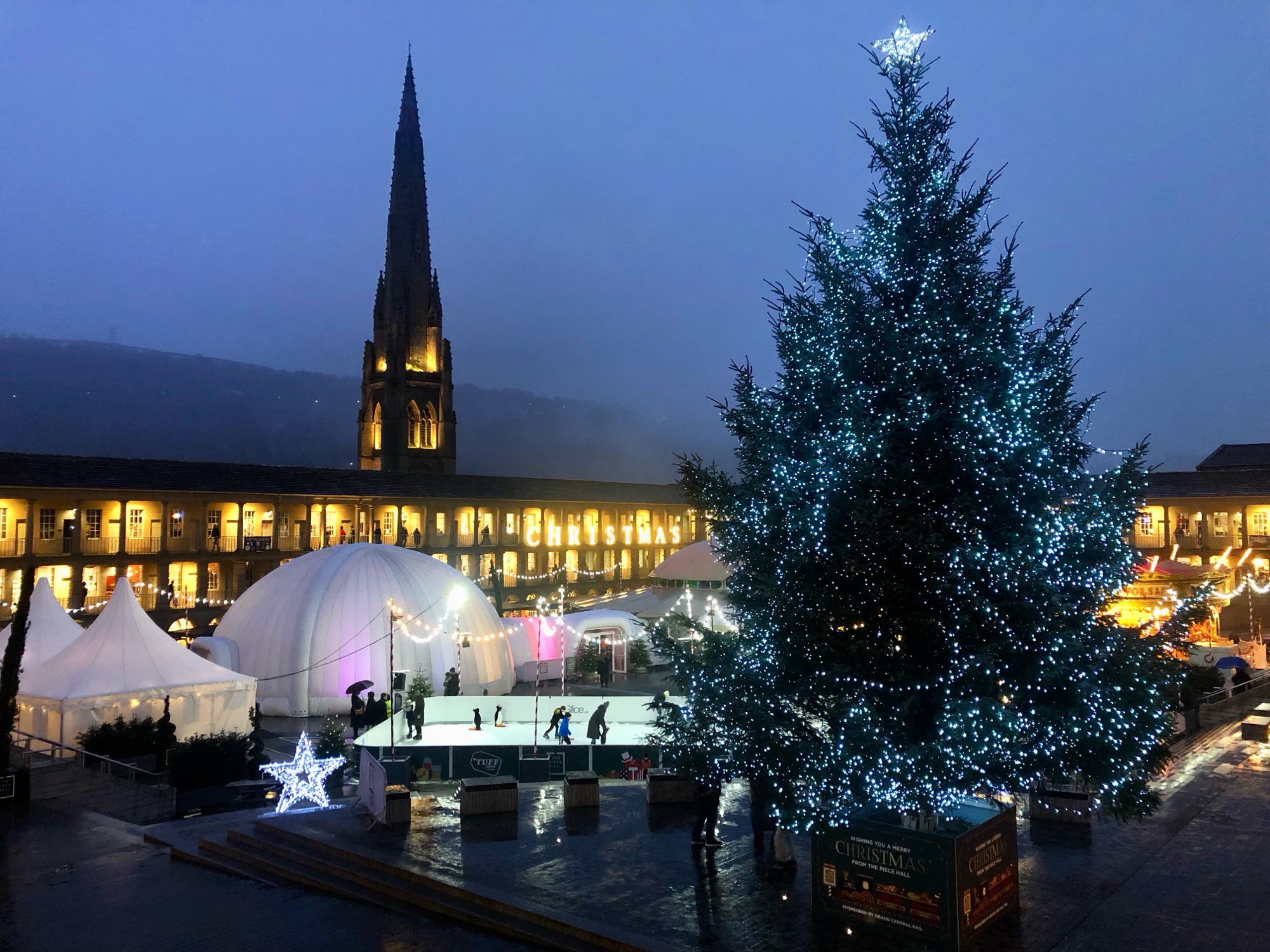 A photo of the Piece Hall in Halifax, taken in December 2022. There's a huge Christmas tree in the courtyard.