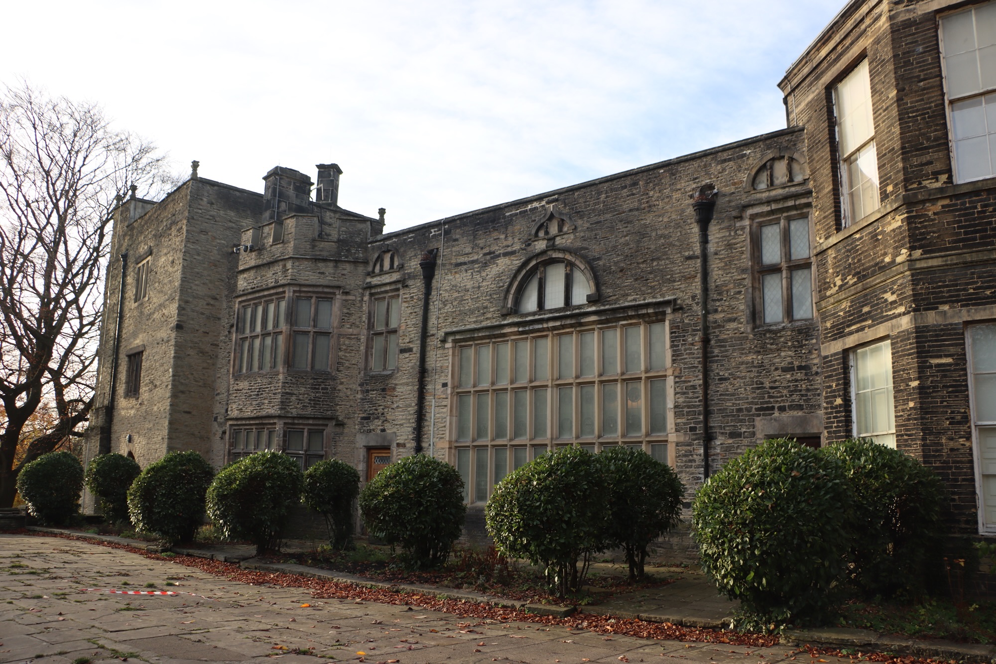 A photo of the outside of the Bolling Hall Museum in Bradford. It's a stone-built stately home.