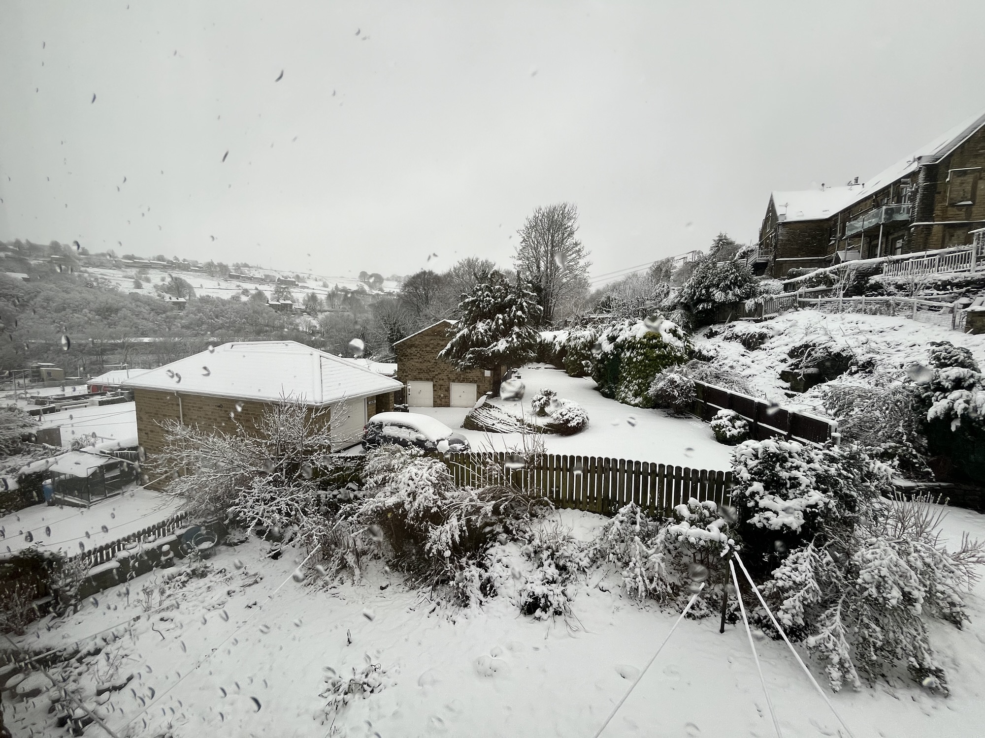 A photo of a snowy scene, taken from our house