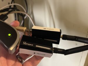 A photo of two dongles, both Sonoff ZBDongle E devices, labelled 'Zigbee' and 'Thread'.