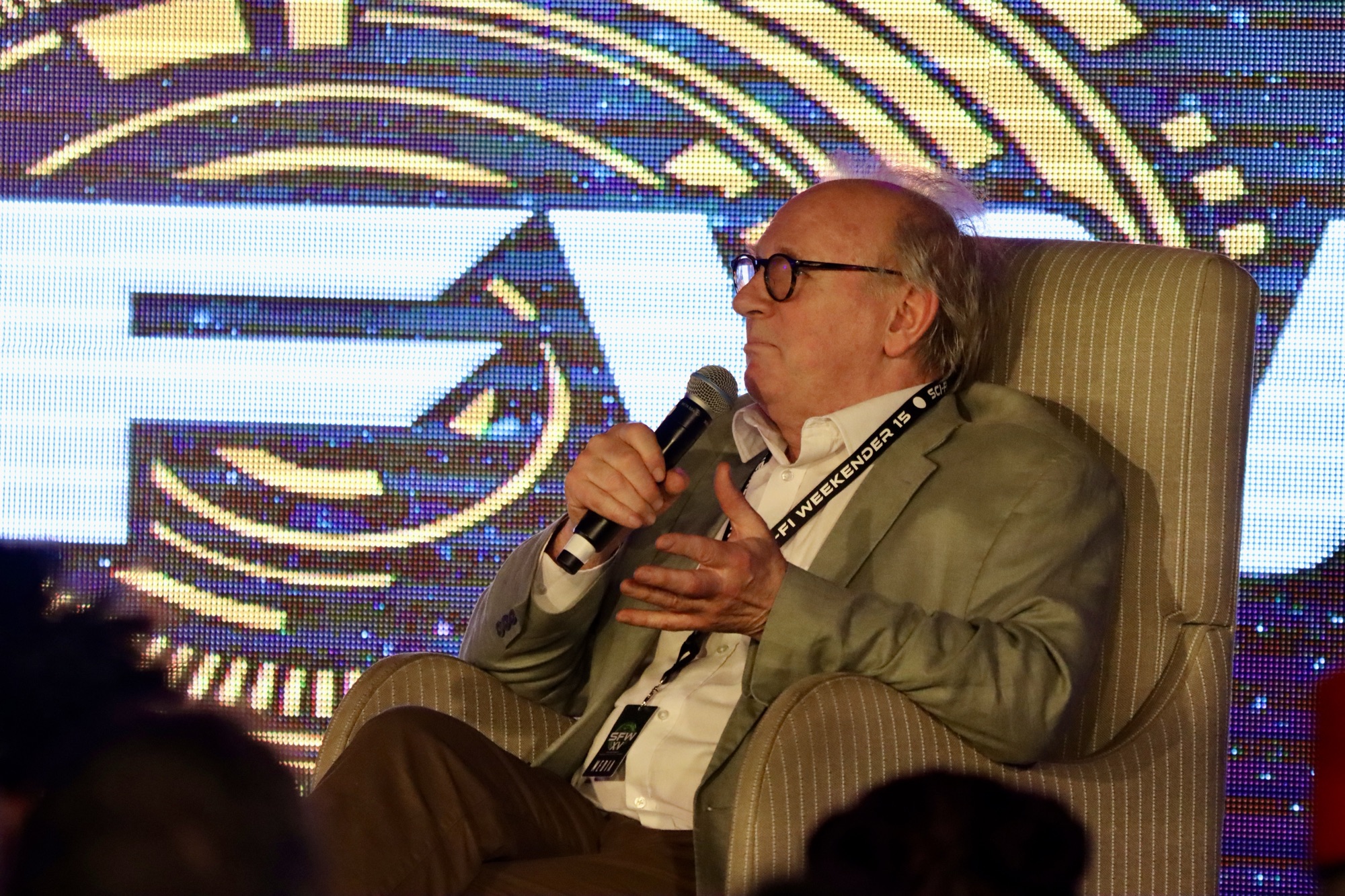 A photo of Peter Davison being interviewed on stage at Sci-Fi Weekender 15