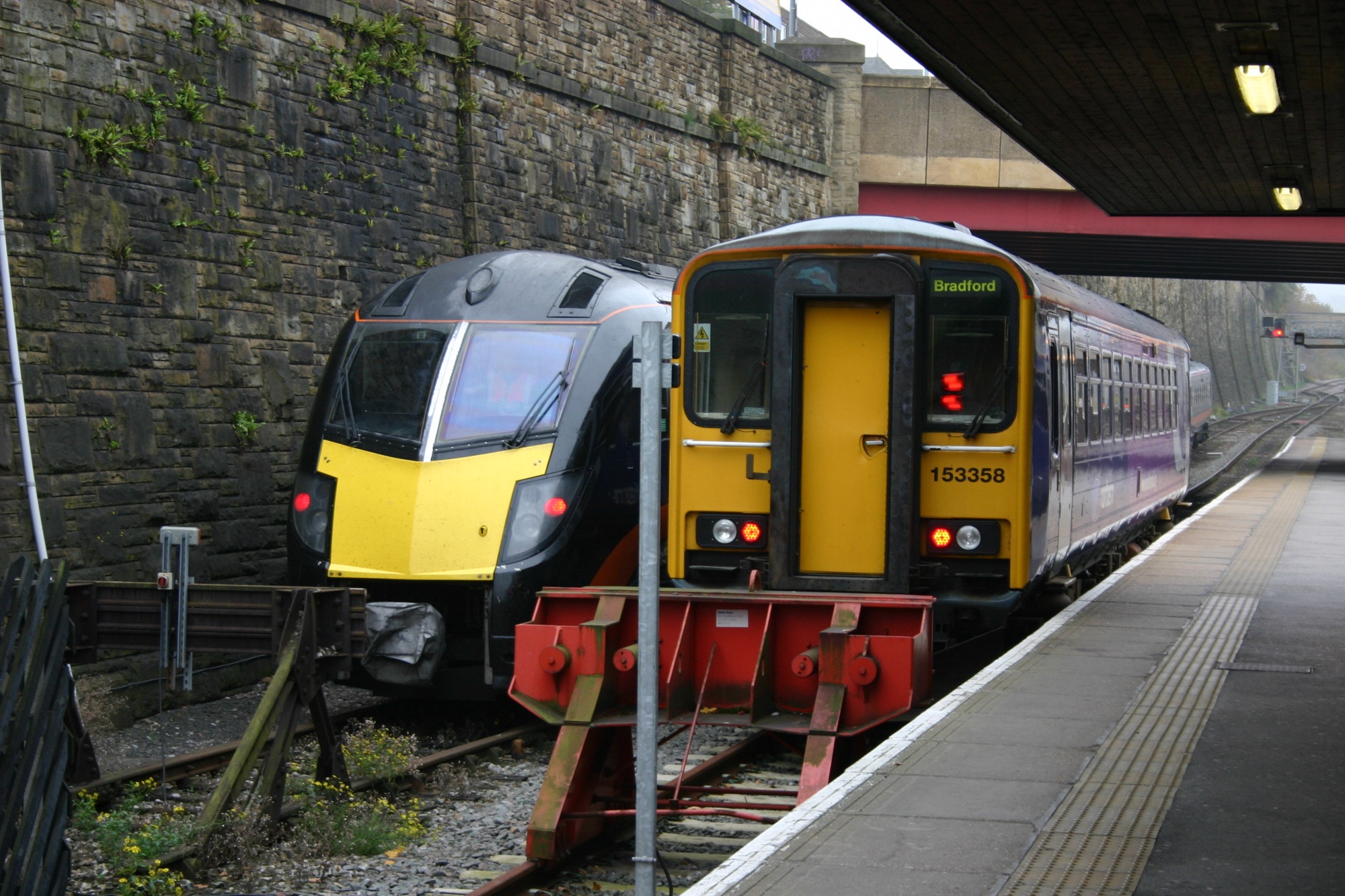 A Grand Central and a Northern train side-by-side at Bradford Interchange, on the Calder Valley line