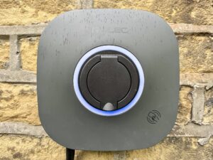 A photo of a Rolec EVO electric car charger mounted on a Yorkshire stone wall