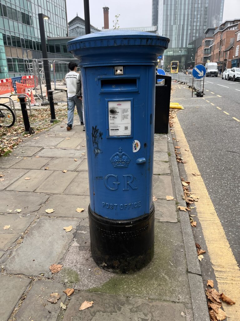 A blue postbox on Liverpool Road in Manchester