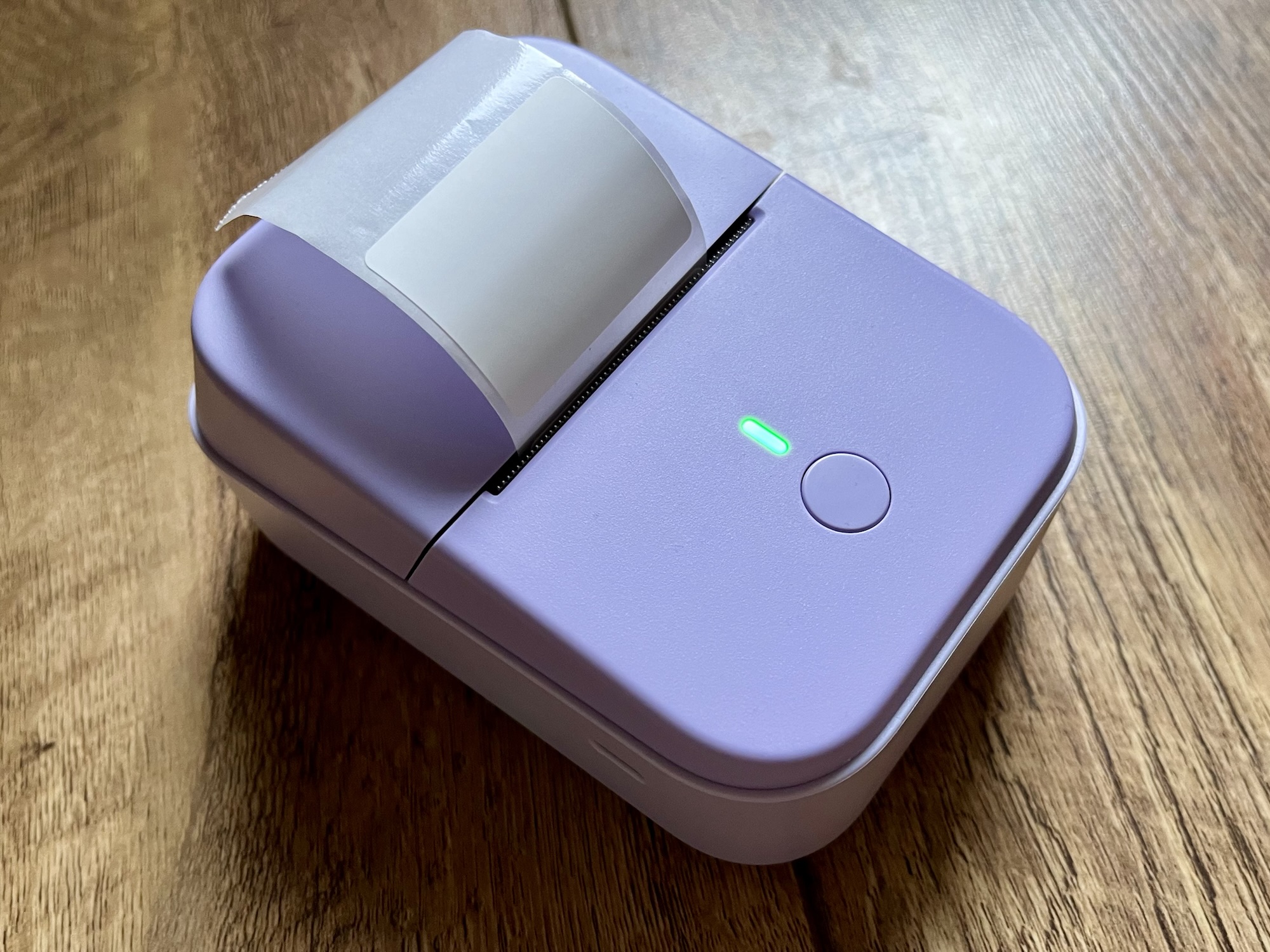 A photo of the Etikez PM260 Bluetooth label printer, in a pastel purple colour.