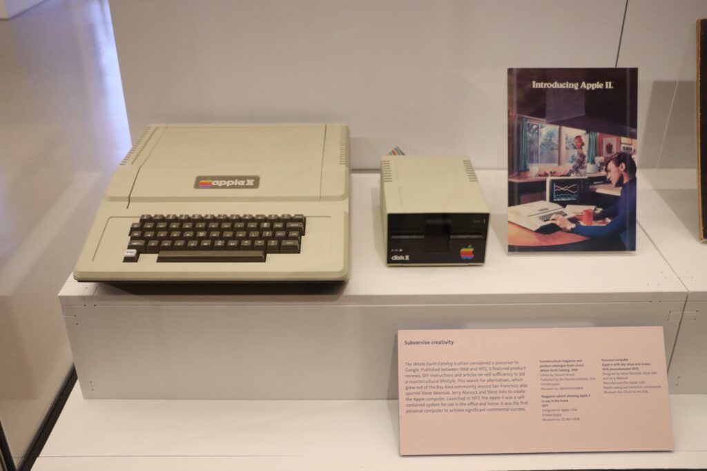 A photo of an Apple II computer and disk drive on display at the V&A