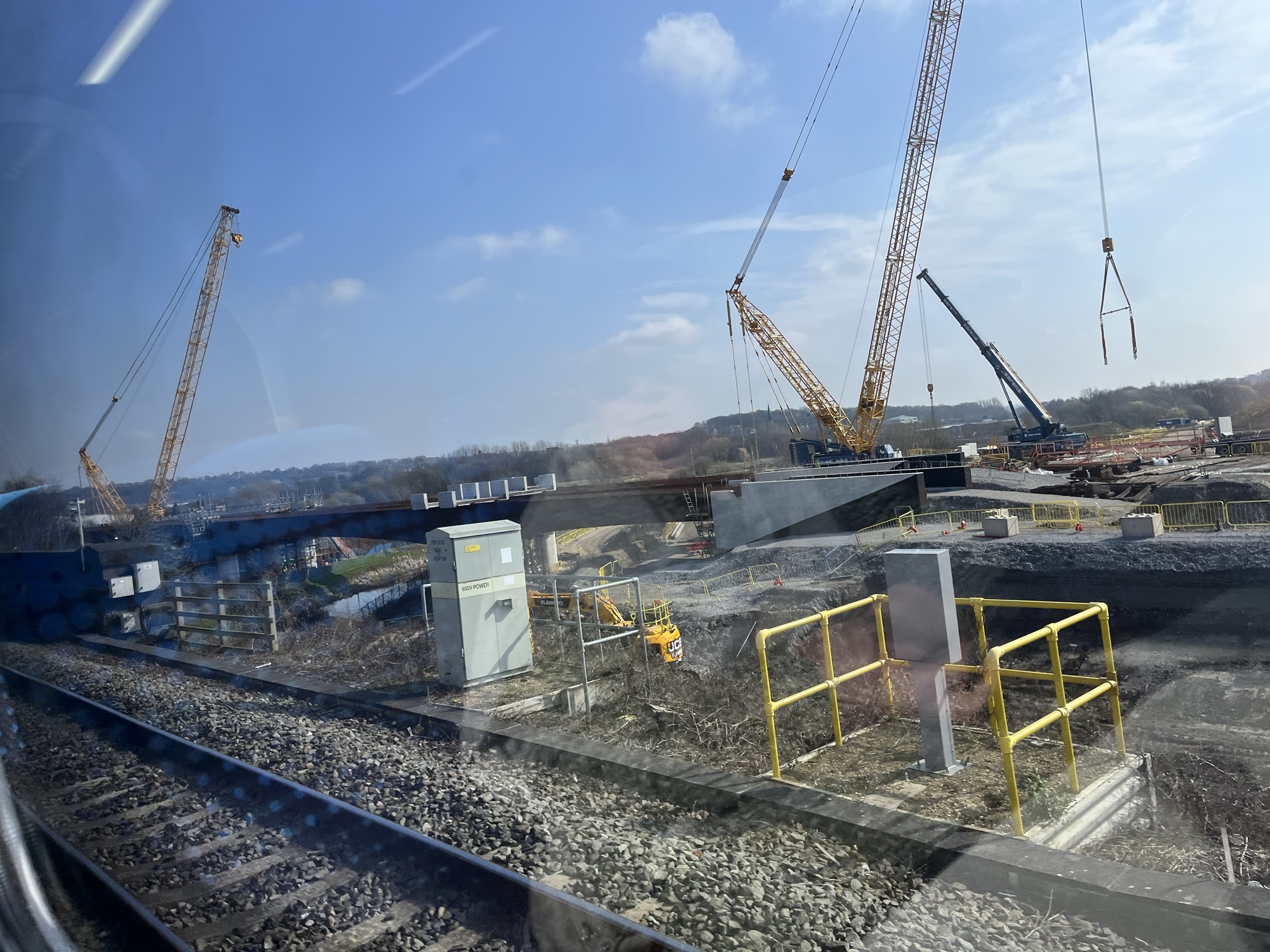 A photo of works on the Transpennine Route Upgrade at Thornhill Junction, taken from a passing train